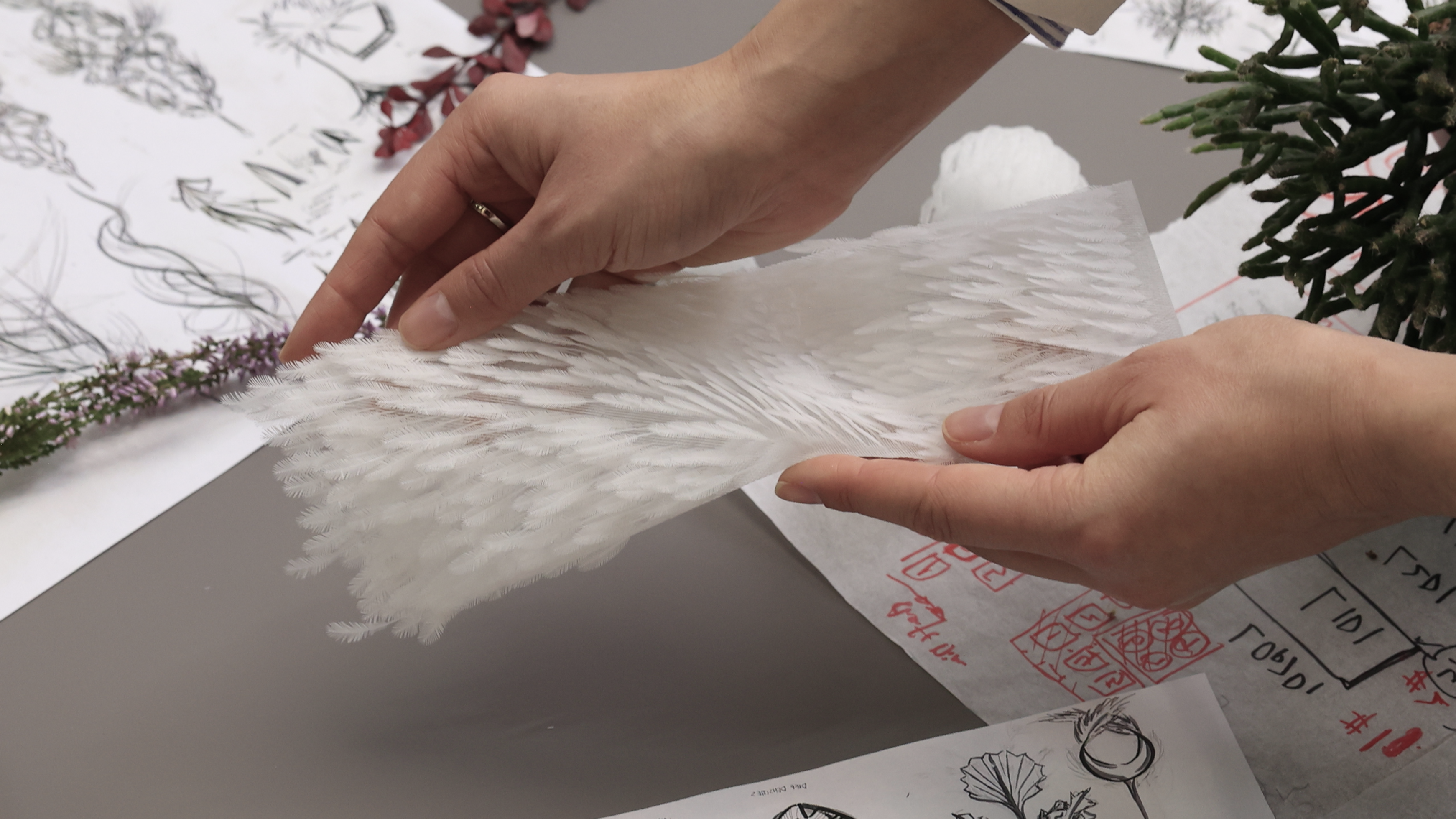 OPT Industries 3D printed feathers being held
